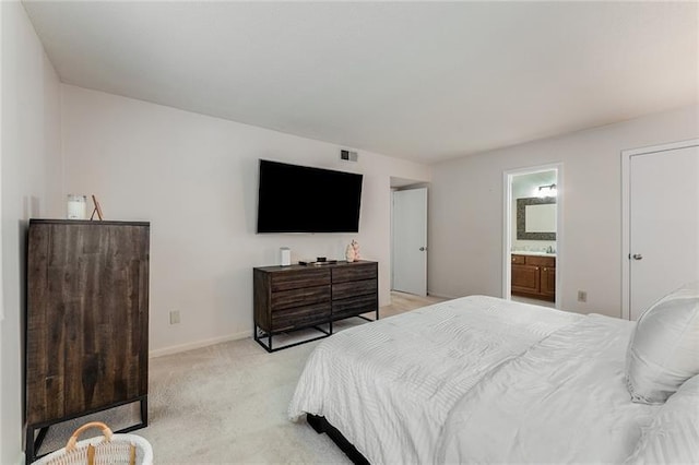 bedroom featuring connected bathroom, visible vents, light colored carpet, and baseboards