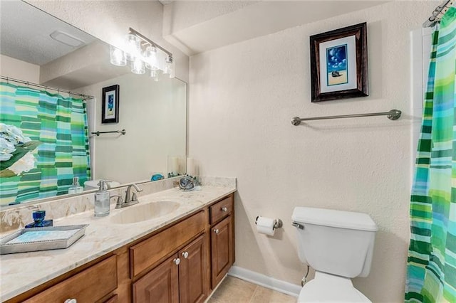 bathroom featuring a shower with curtain, vanity, tile patterned floors, toilet, and baseboards