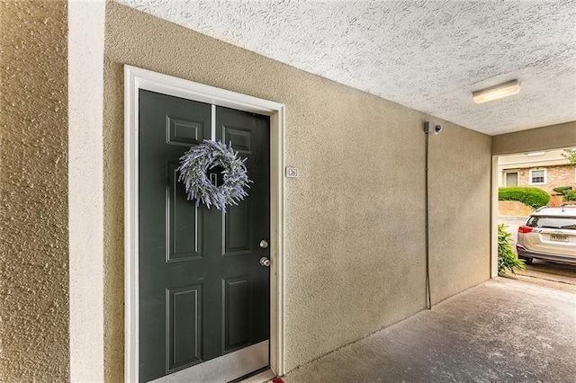 entrance to property featuring stucco siding