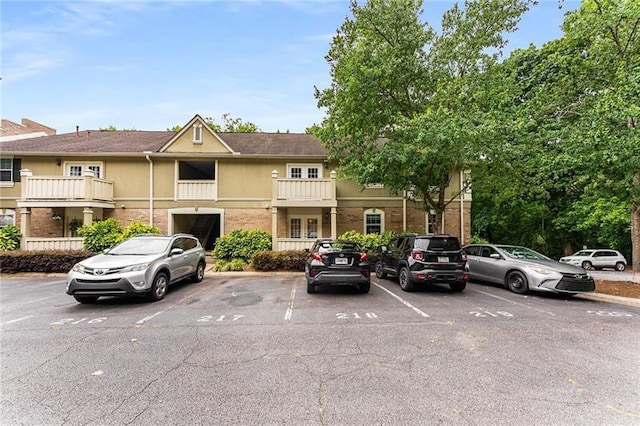 view of property featuring uncovered parking