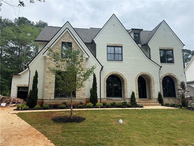 344 Michael Dr, Alpharetta, GA 30009 - french country inspired facade featuring stone siding, a front lawn, brick siding, and a shingled roof