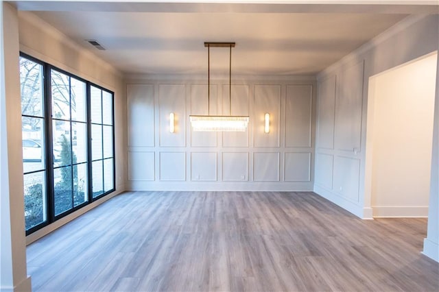 344 Michael Dr, Alpharetta, GA 30009 - unfurnished dining area featuring a decorative wall, light wood-type flooring, ornamental molding, and baseboards
