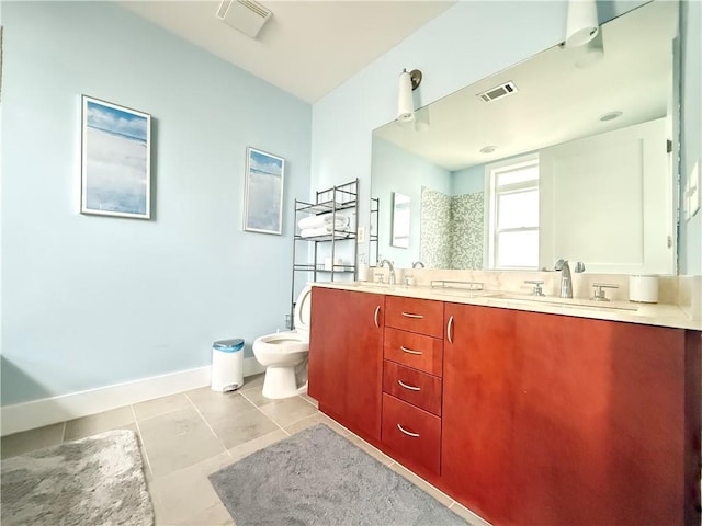 3655 Peachtree Rd NE Unit 304, Atlanta, GA 30319 - bathroom featuring tile patterned floors, baseboards, double vanity, and toilet