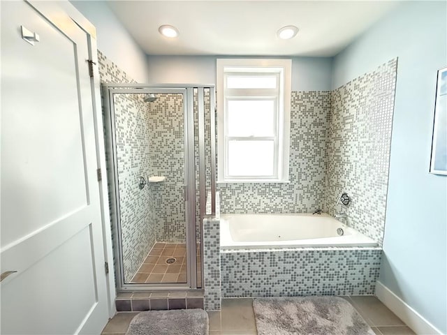 3655 Peachtree Rd NE Unit 304, Atlanta, GA 30319 - bathroom featuring tile patterned flooring, a stall shower, and a garden tub