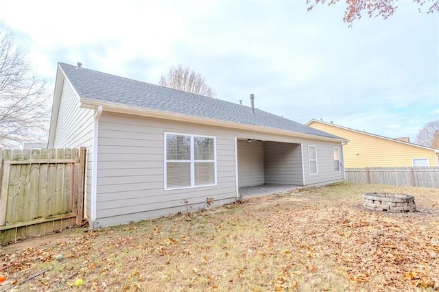 rear view of house featuring an outdoor fire pit