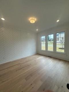 unfurnished room with wood finished floors and recessed lighting