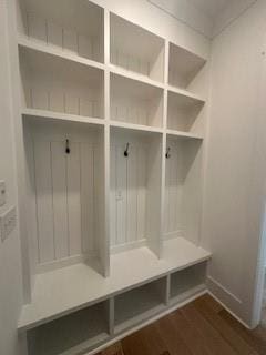 mudroom with dark wood-style flooring and baseboards