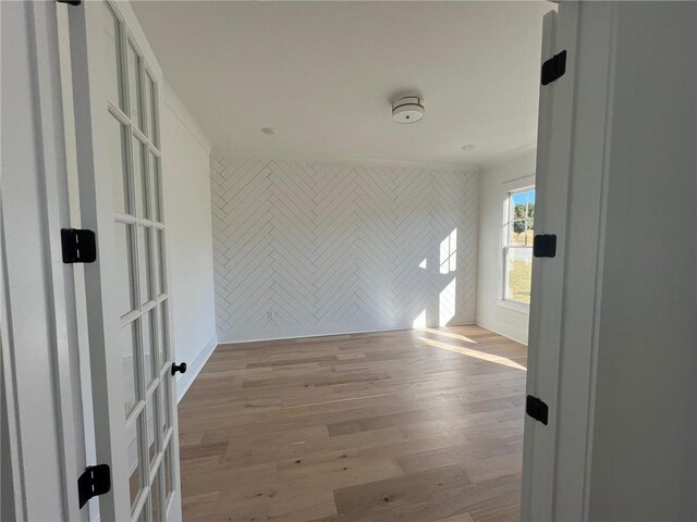 empty room featuring baseboards and light wood finished floors