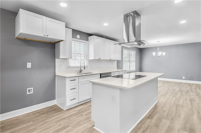 kitchen with a sink, island exhaust hood, black electric cooktop, and white cabinets