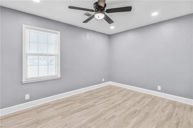 spare room featuring light wood finished floors, recessed lighting, visible vents, a ceiling fan, and baseboards