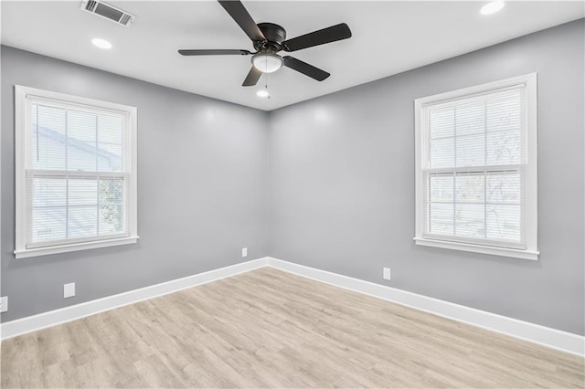 unfurnished room with baseboards, visible vents, and a healthy amount of sunlight