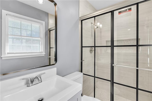 bathroom featuring toilet, a tile shower, and vanity