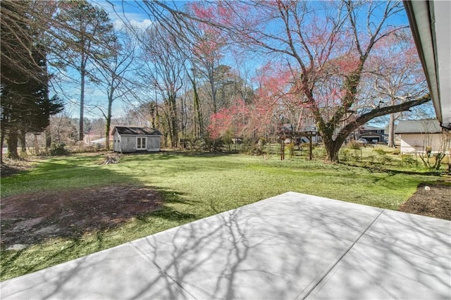 view of yard featuring a patio area and an outdoor structure