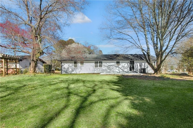 back of house featuring a lawn and a pergola