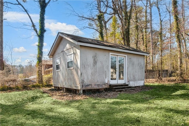 view of outbuilding featuring fence and an outdoor structure