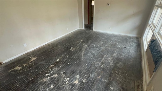 interior space with baseboards and wood finished floors