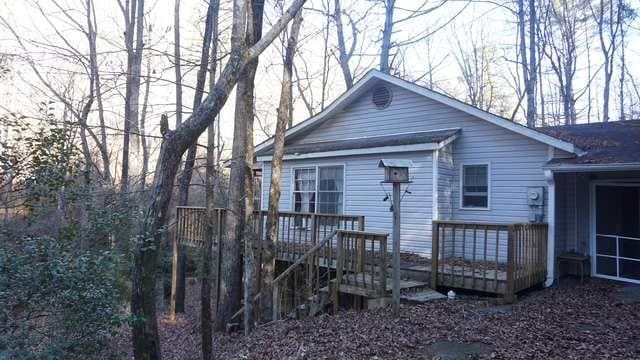 back of house featuring a wooden deck