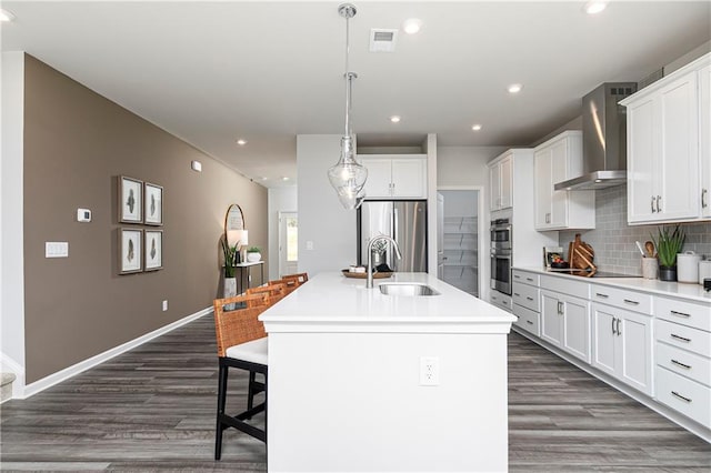 505 Regency Trl, Acworth, GA 30102 - kitchen with wall chimney range hood, a sink, appliances with stainless steel finishes, dark wood-style flooring, and backsplash
