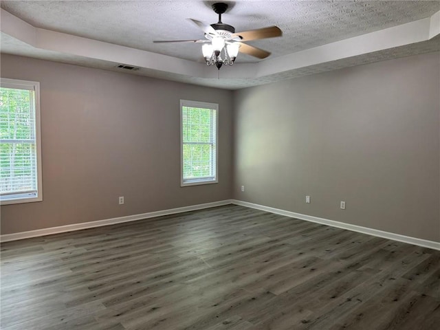 7454 Woody Springs Dr, Flowery Branch, GA 30542 - spare room featuring a textured ceiling, a tray ceiling, dark wood-style flooring, baseboards, and ceiling fan