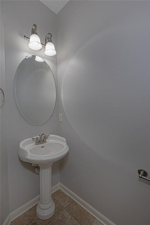 bathroom with tile patterned floors and baseboards