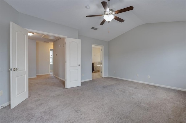 unfurnished bedroom featuring visible vents, connected bathroom, baseboards, carpet, and lofted ceiling