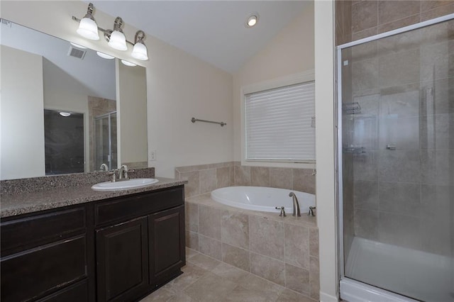 bathroom with visible vents, a shower stall, vaulted ceiling, a bath, and vanity