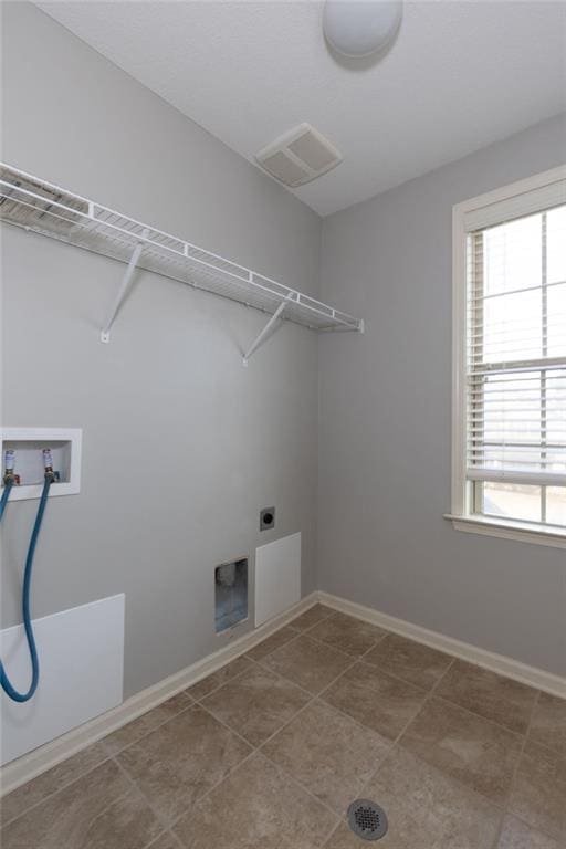 clothes washing area featuring visible vents, baseboards, laundry area, hookup for a washing machine, and electric dryer hookup