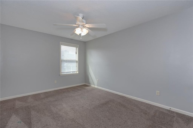 spare room with baseboards, carpet floors, and a ceiling fan