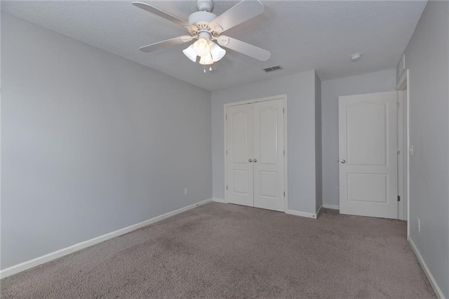 unfurnished bedroom featuring visible vents, baseboards, a closet, and carpet flooring