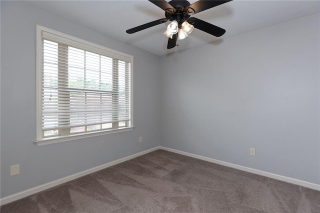 carpeted empty room with baseboards and ceiling fan