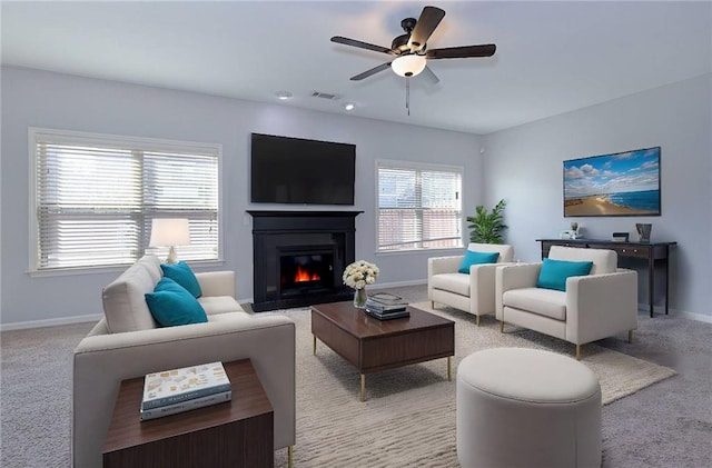 living room with visible vents, baseboards, and light colored carpet