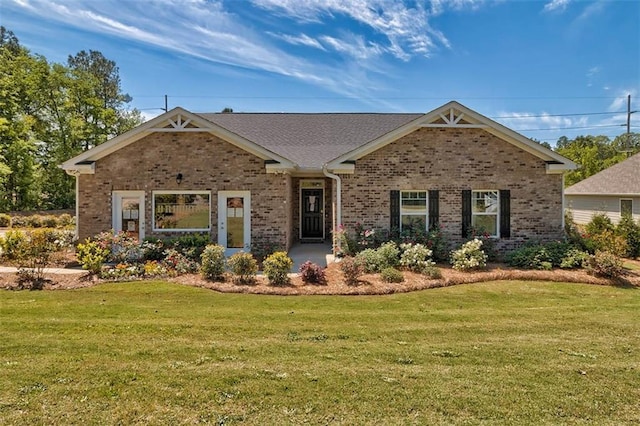 view of front of home with brick siding and a front yard