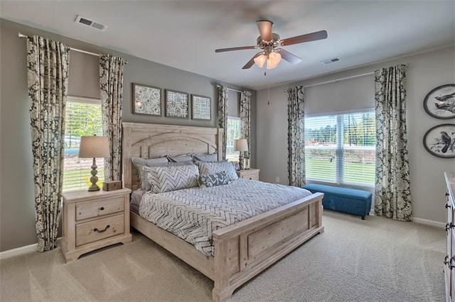 bedroom featuring baseboards, visible vents, and light colored carpet