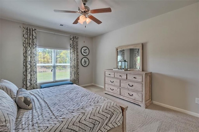 bedroom with baseboards, visible vents, ceiling fan, and light colored carpet