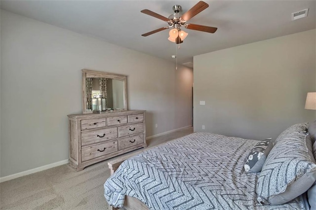 bedroom with a ceiling fan, light colored carpet, visible vents, and baseboards