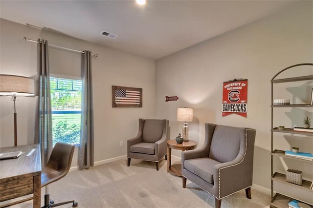 office featuring carpet floors, visible vents, and baseboards