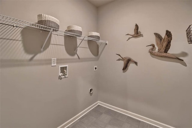 laundry area with laundry area, baseboards, tile patterned floors, hookup for an electric dryer, and washer hookup