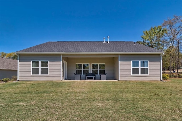 rear view of house with a patio, roof with shingles, a lawn, and an outdoor living space