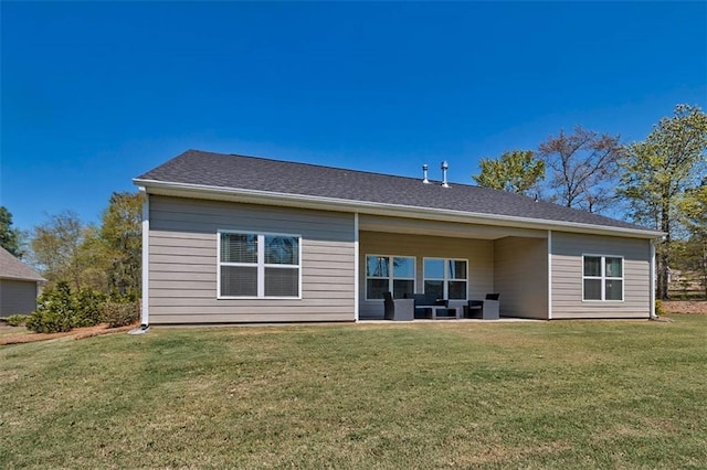 rear view of house featuring a yard