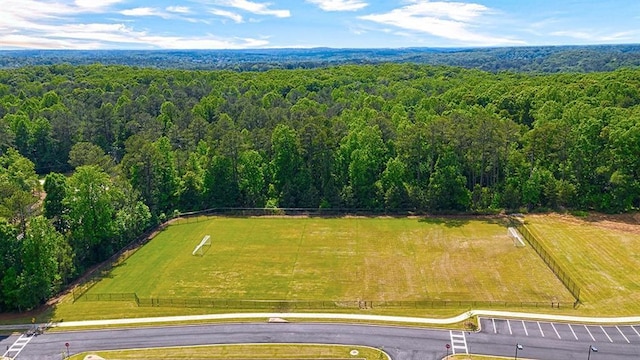 drone / aerial view featuring a wooded view