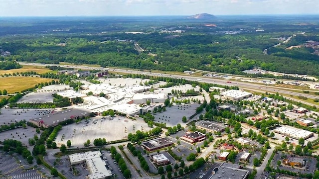 drone / aerial view with a wooded view