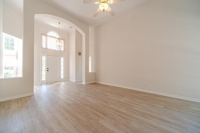 entryway featuring ornamental molding, a healthy amount of sunlight, ceiling fan, and light hardwood / wood-style flooring