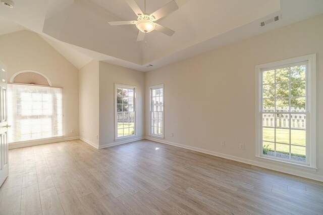 unfurnished dining area featuring a notable chandelier, a high ceiling, and light wood-type flooring