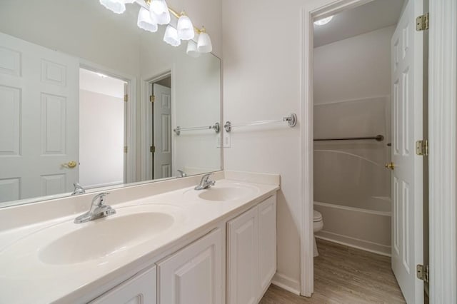 bathroom featuring vanity, toilet, and hardwood / wood-style floors