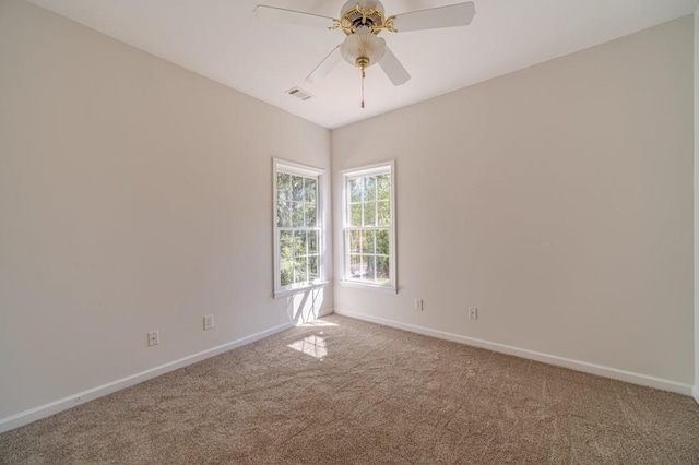 unfurnished room featuring ceiling fan and carpet flooring