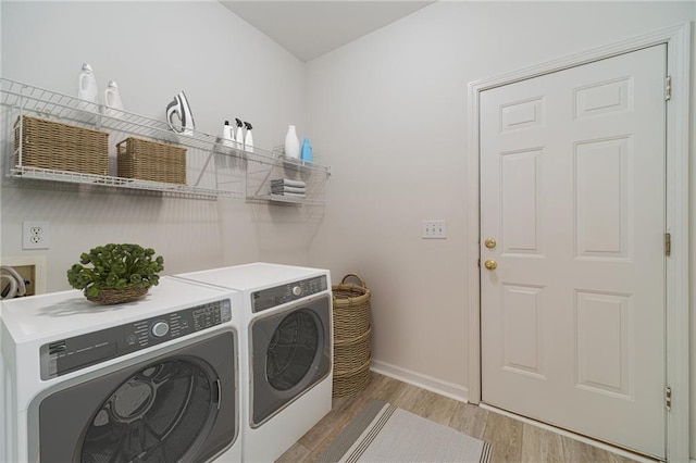 laundry area with hardwood / wood-style flooring and washer and dryer