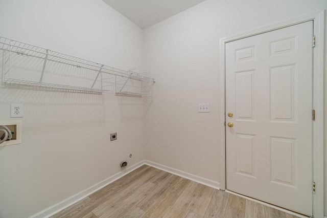 laundry area featuring electric dryer hookup, washer hookup, and light wood-type flooring