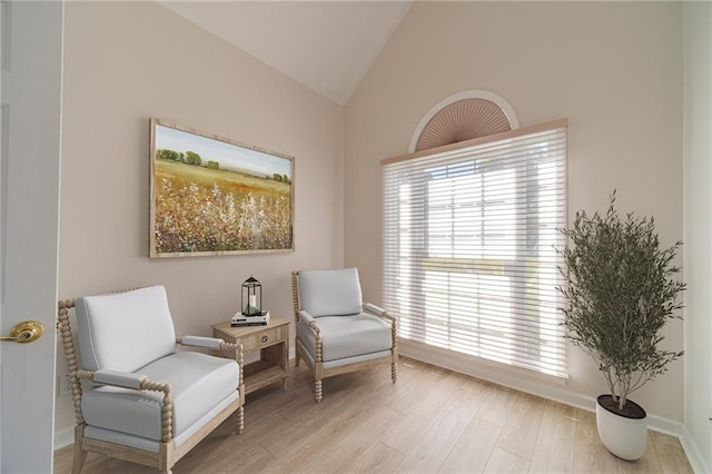 sitting room with vaulted ceiling and light hardwood / wood-style floors