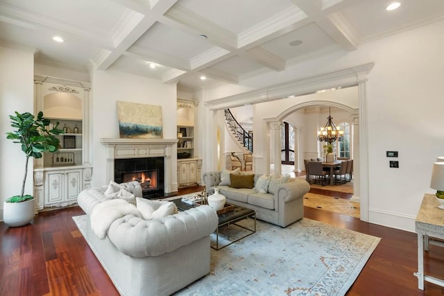 living room with coffered ceiling, beam ceiling, dark wood-type flooring, and a tiled fireplace