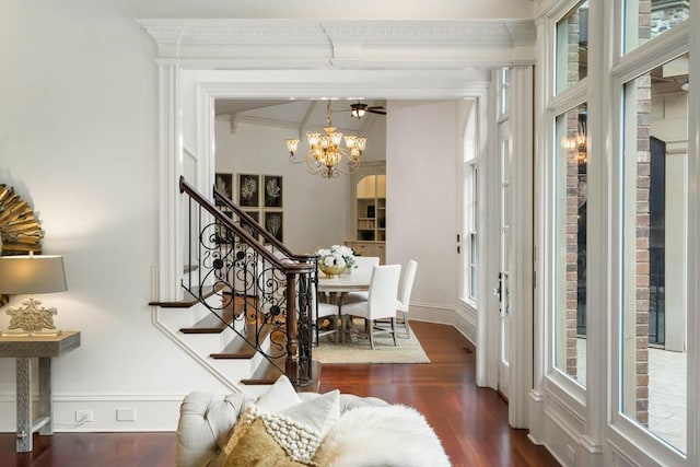 dining room featuring dark hardwood / wood-style flooring, an inviting chandelier, and ornamental molding